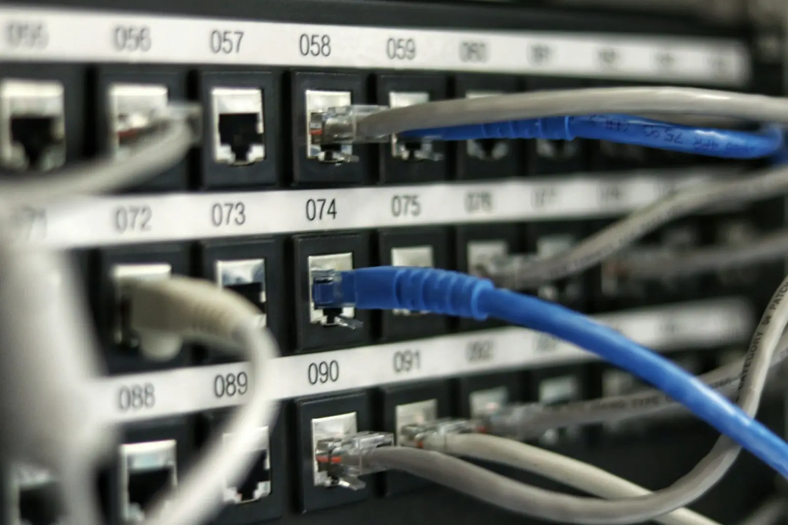 Rows of network cabling in a datacenter rack